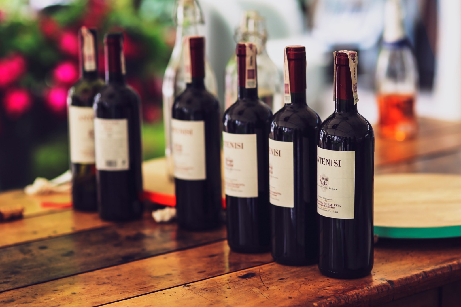 Bottles of red wine on a table, representing winery revenue and profit by product